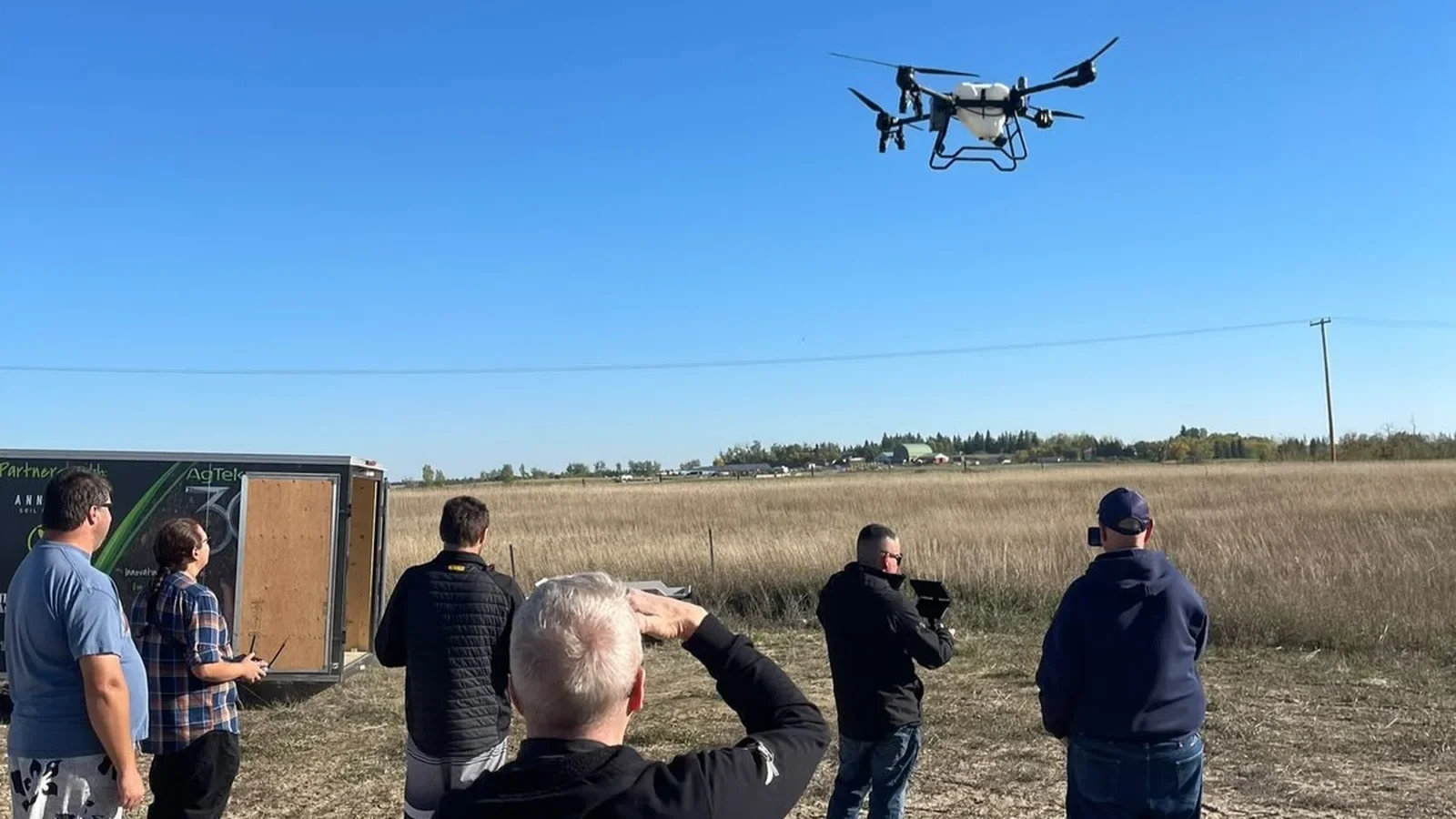 Attendees viewing EAVISION J150 at Regina agricultural drone demonstration