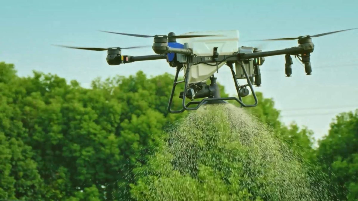 EAVISION J150 agricultural drone spreading granular material over a field